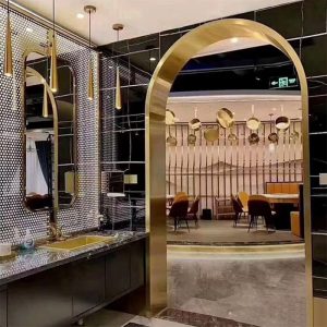 High-end restaurant club interior decorative archway with polished gold stainless steel finish for luxury venue entrance, lounge area divider, and upscale architectural statement piece