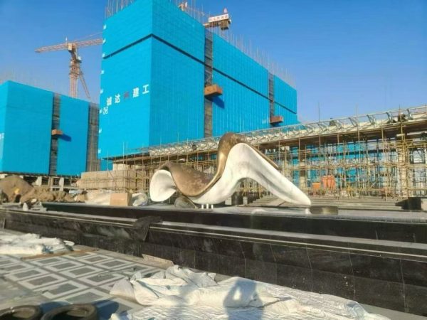 Metal sculpture installation and hoisting process in progress by XinYe Metal