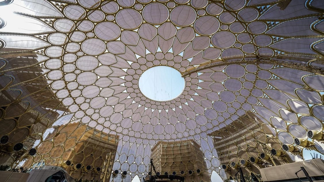 Night view of UAE iconic buildings with illuminated stainless steel structures by leading engineering firms.