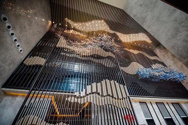 XinYe Metal custom stainless steel screen designed and installed in a luxury hotel lobby entrance area