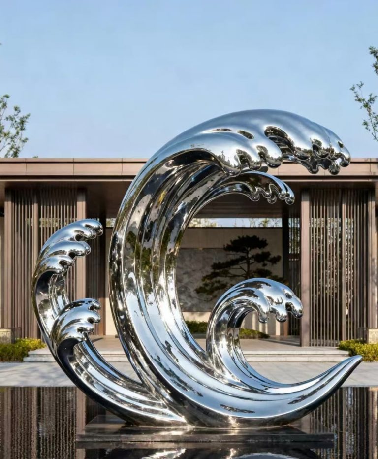 Sleek curved stainless steel water feature reflecting sky and landscape