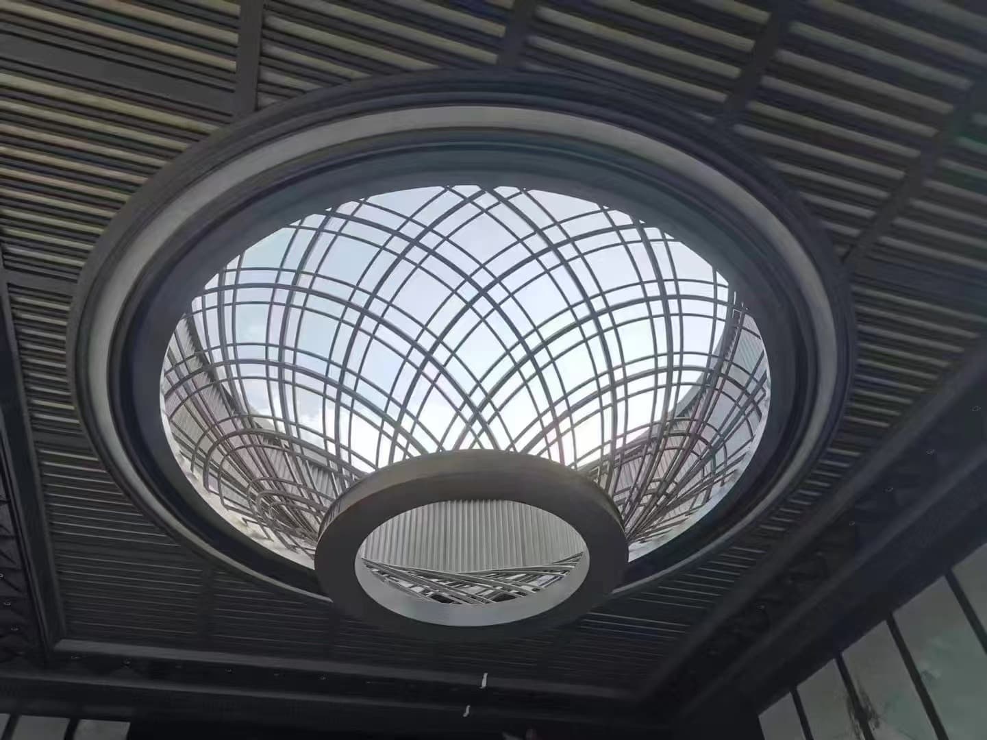 Large stainless steel dome ceiling custom-made by XinYe Metal for grand interior spaces.