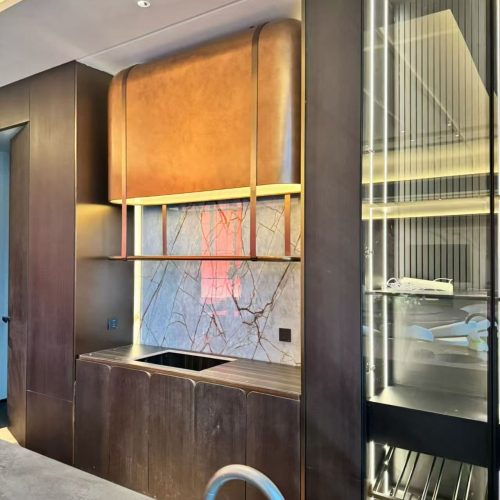 Custom antique bronze stainless steel decorative hanging cabinet with warm metallic finish, sleek floating design, and refined detailing, installed in a luxury interior setting.