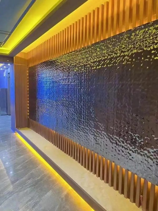 Decorative water ripple metal panel reflecting light in silver blue tones